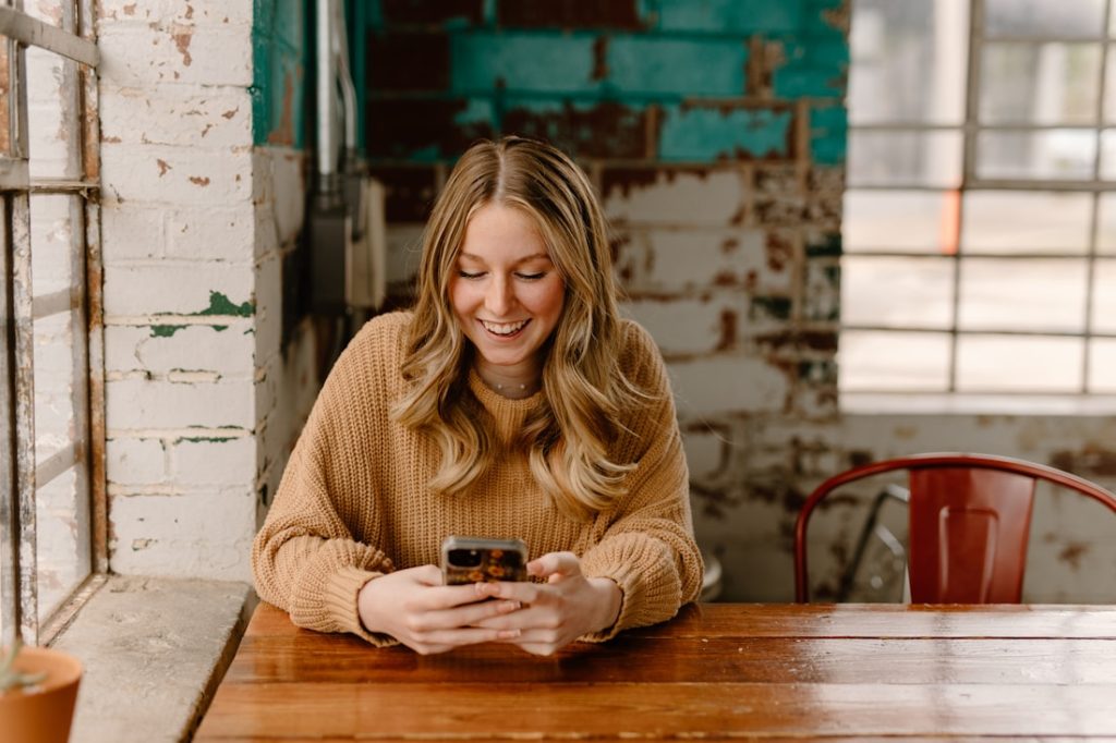 Woman smiling while booking a hair growth telehealth consultation with Aura Wellness